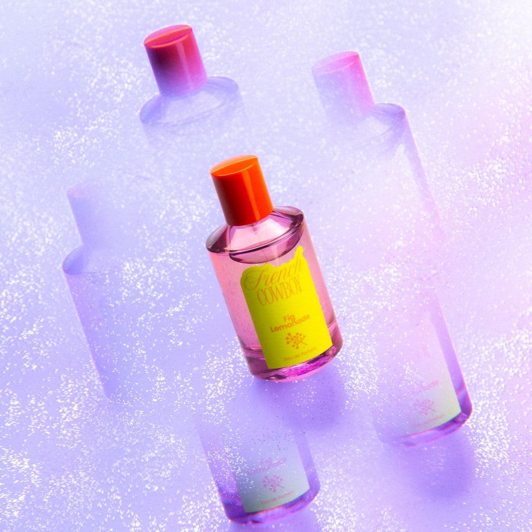 French Cowboy Fig Lemonade bottle with reflections on a lilac background