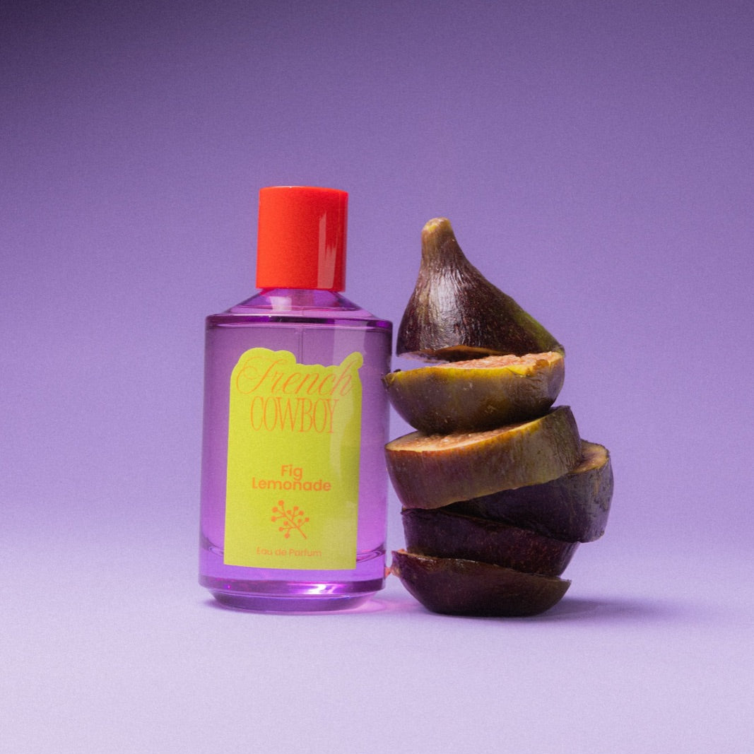 French Cowboy Fig Lemonade bottle beside a sliced fig